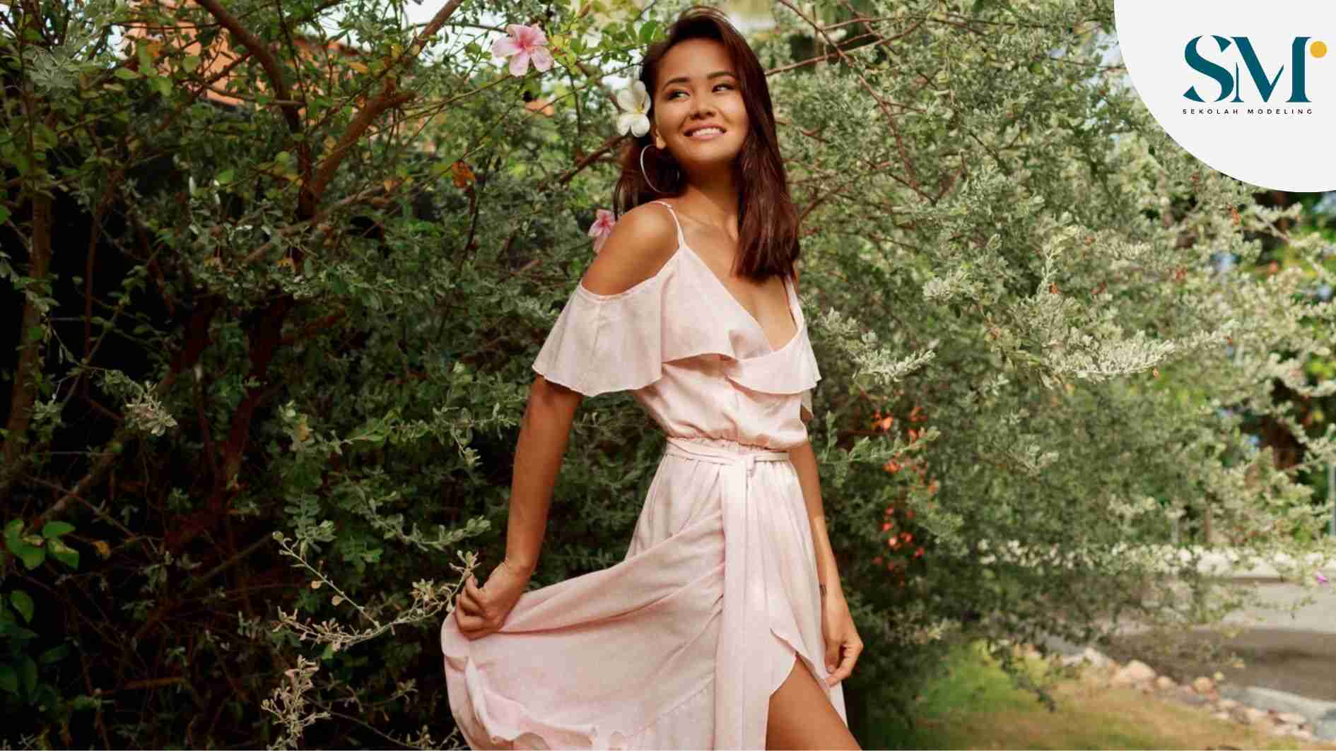 Happy graceful Asian woman walking in the park in summer sunny day
