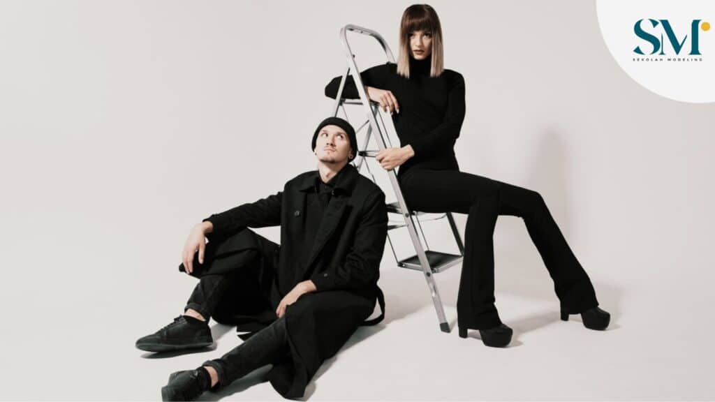 Fashionable man and woman sitting on a stair