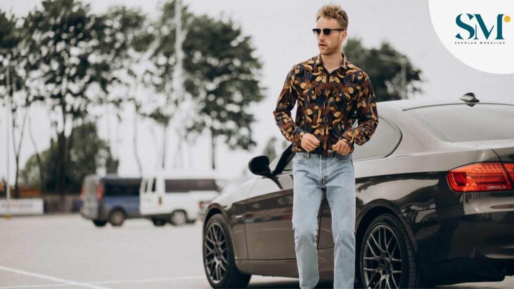 Young handsome man standing by car