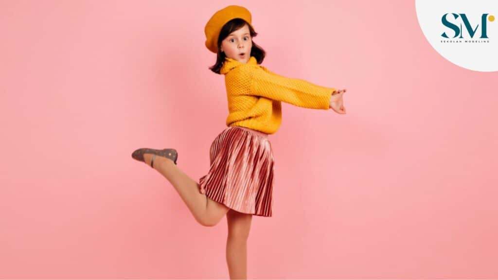 carefree child jumping on pink wall